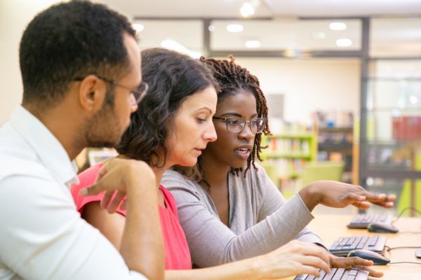 Group learning together during a computer training session.